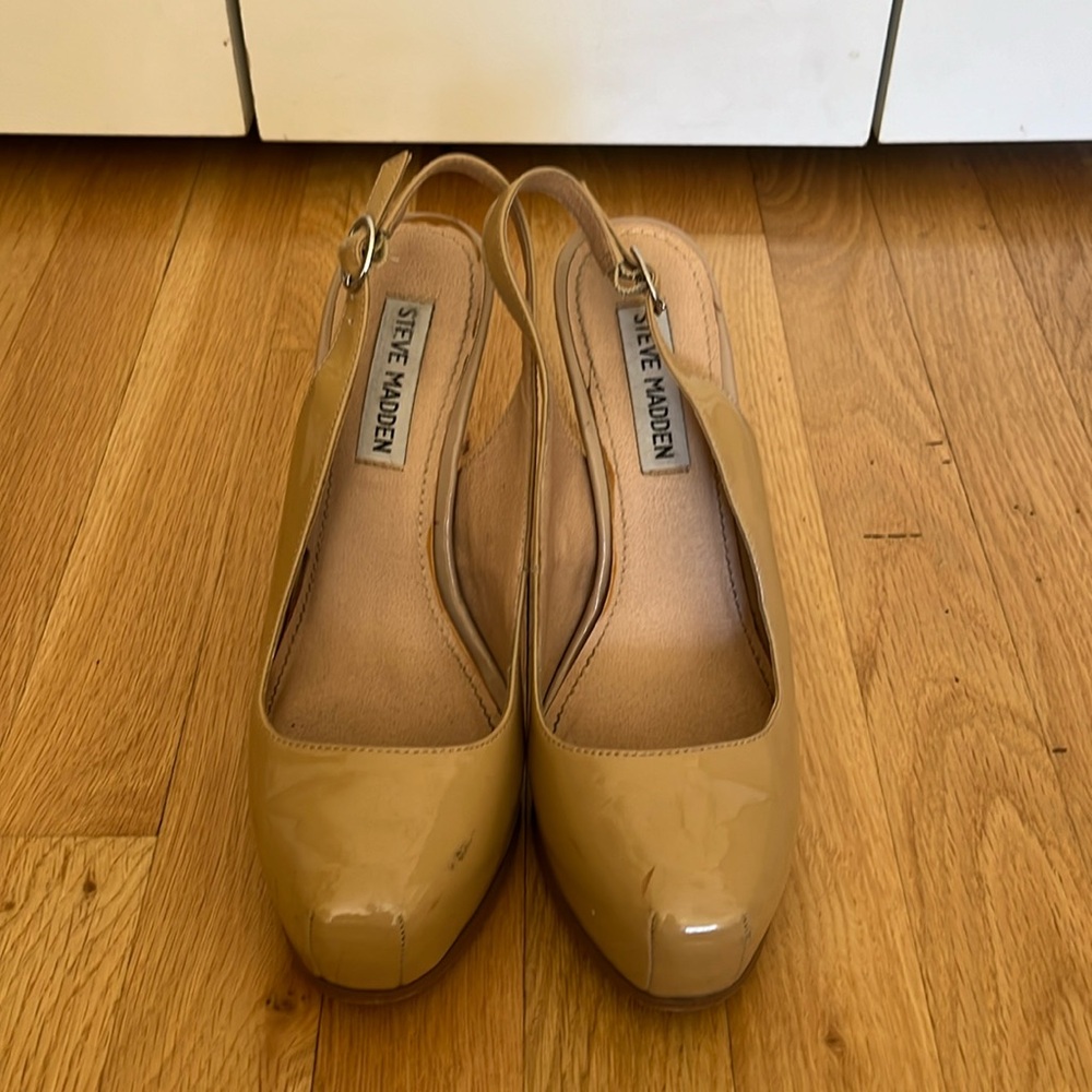 Steve Madden patent sling back pumps.
